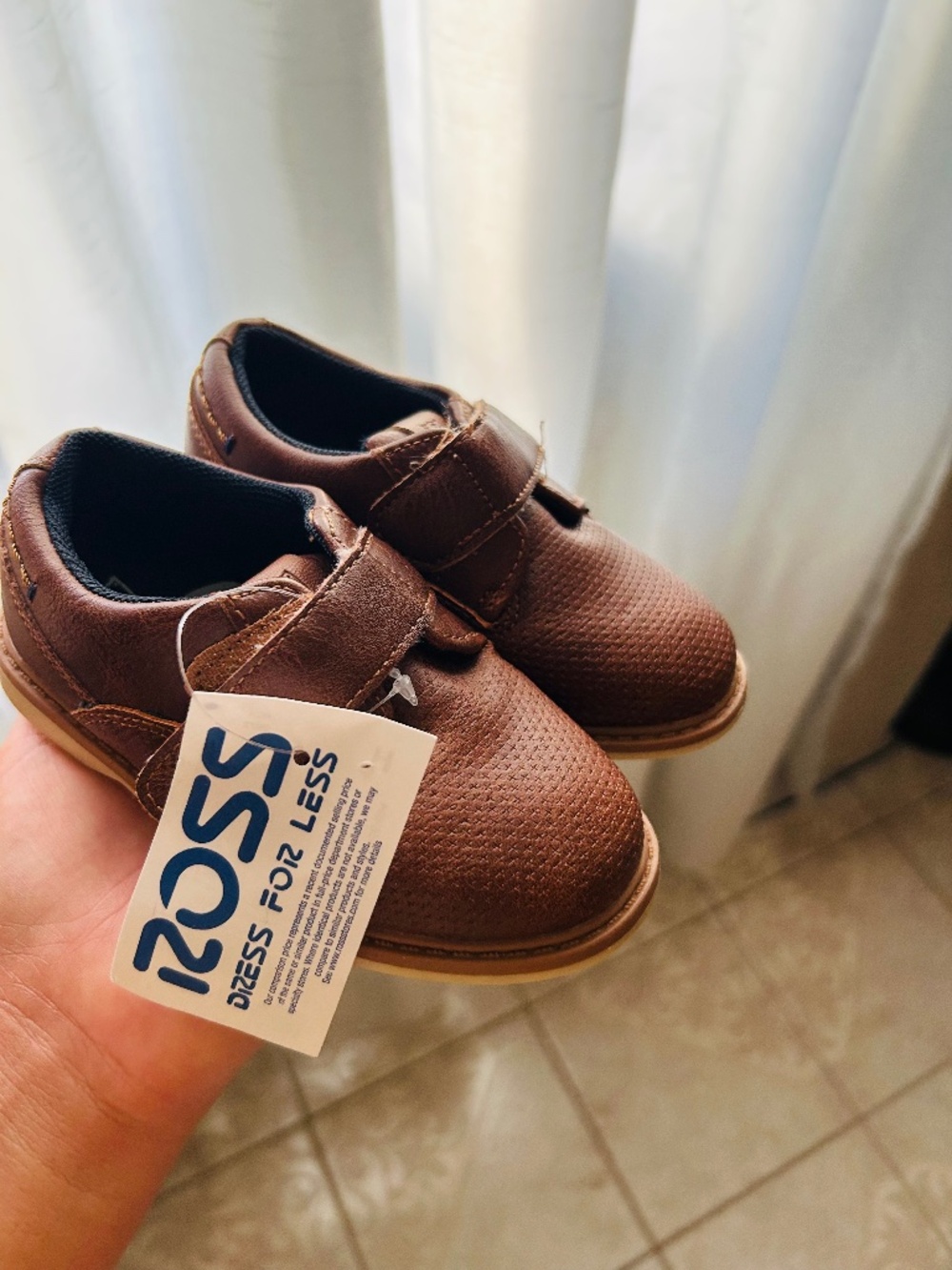 Brown London Underground boys' casual dress shoes feature a strap closure.